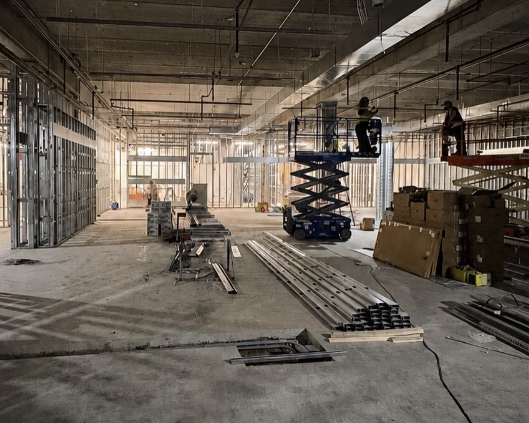 Large commercial tenant improvement space with scissor lifts