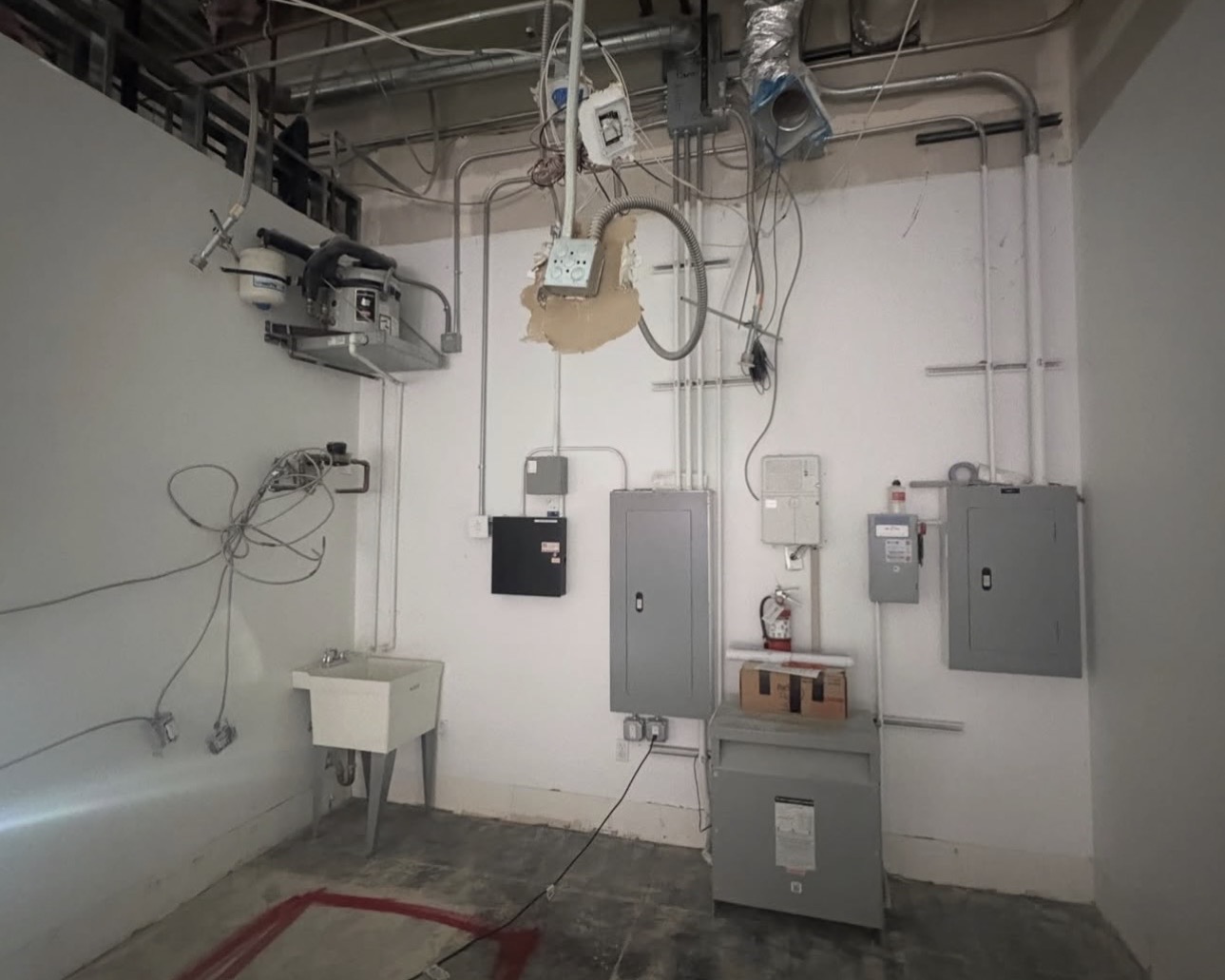 Commercial electrical room with multiple panels and a transformer